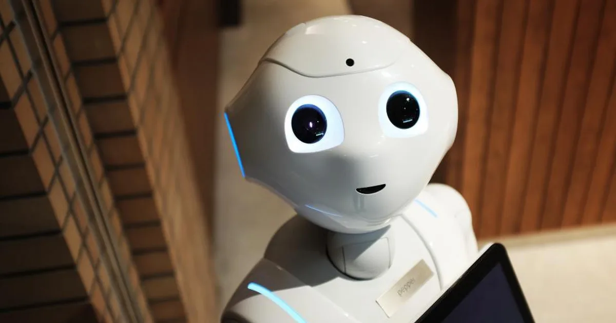 Robot humanoide blanco sosteniendo una tableta, representando la inteligencia artificial